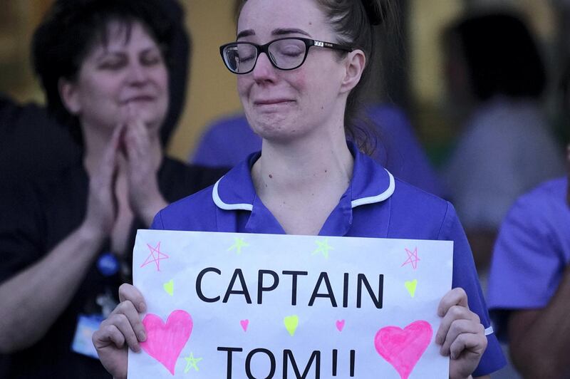 LIVERPOOL,  UNITED KINGDOM- APRIL 16:  A nurse at Aintree University Hospital sheds a tear and as she pays tribute to super fundraiser during the "Clap for Our Carers" and the NHS on April 16, 2020 in Liverpool, United Kingdom. Following the success of  the "Clap for Our Carers" campaign, members of the public are being encouraged to applaud NHS staff and other key workers from their homes at 8pm every Thursday. The Coronavirus (COVID-19) pandemic has infected over 2 million people across the world, claiming at least 13,729 lives in the U.K. (Photo by Christopher Furlong/Getty Images)