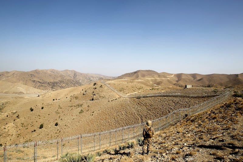 A soldier on guard along the border fence near the Kitton outpost on the border with Afghanistan in North Waziristan, Pakistan. Reuters