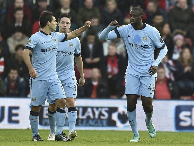 Manchester City's Yaya Toure, right, celebrates with teammates Sergio Aguero, right, and Samir Nasri, centre, after scoring in City's win over Southampton on Sunday in the Premier League. Toby Melville / Reuters / November 30, 2014 