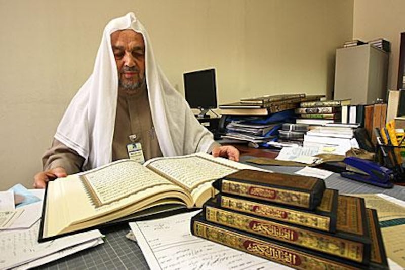 Dr Mohammed Motei El Hafez, the head of the Sheikh Maktoum Mushaf Technical Committee, reads from a Quran produced in the UAE.