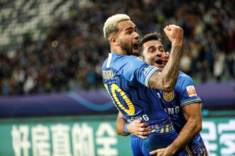 (FILES) This file photo taken on November 12, 2020 shows Jiangsu Suning's Alex Teixeira (L) who scored a goal celebrating after his team won the Chinese Super League (CSL) final football match between Guangzhou Evergrande and Jiangsu Suning in Suzhou in China's eastern Jiangsu province. Chinese Super League champions Jiangsu FC have "ceased operations", the club said on February 28, 2021, underlining the financial problems coursing through football in the country.
 -  - China OUT
 / AFP / STR
