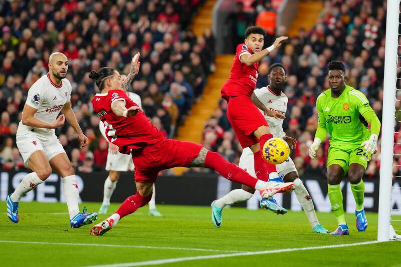 Liverpool's Darwin Nunez, centre left, challenges for the ball. AP 