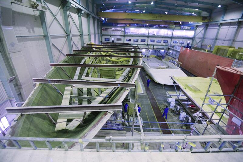 Yachts being built from scratch in the production warehouse of the Gulf Craft factory in Umm Al Quwain. Sarah Dea / The National