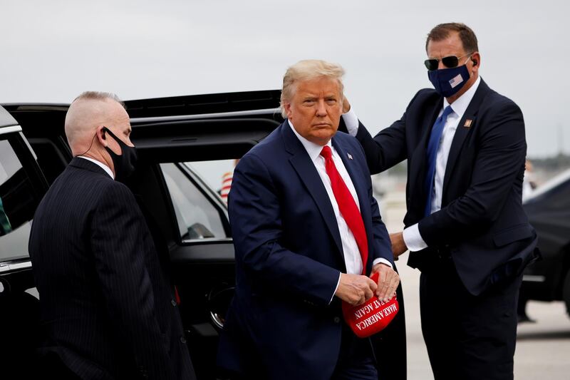 FILE PHOTO: U.S. President Donald Trump arrives to board the Air Force One as he departs Miami for campaign travel to North Carolina, Pennsylvania, Michigan, and Wisconsin at Miami International Airport in Miami, Florida, U.S., November 2, 2020. REUTERS/Carlos Barria/File Photo