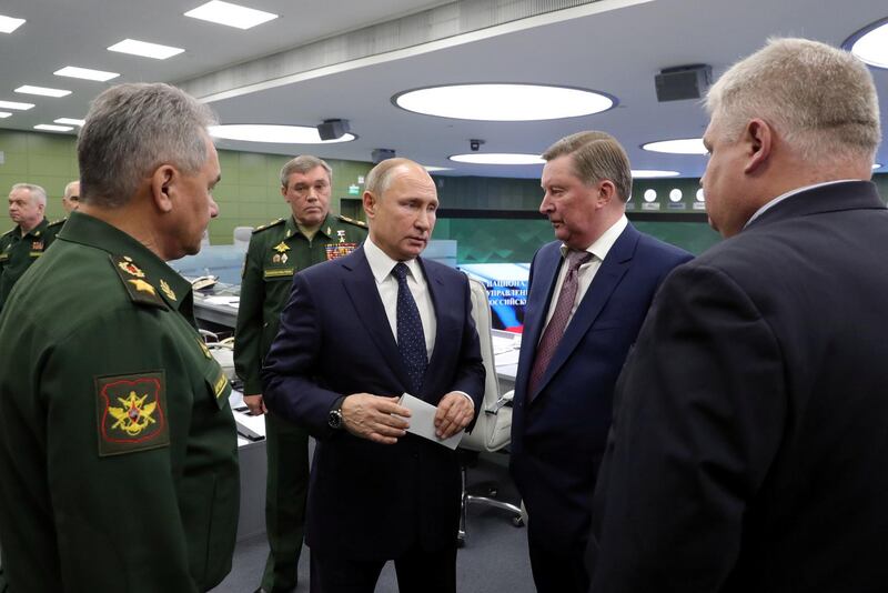 Russia's President Vladimir Putin (C) speaks with Special Presidential Representative for Environmental Protection, Ecology and Transport Sergei Ivanov (2nd R), Defence Minister Sergei Shoigu (L) and Chief of the General Staff of Russian Armed Forces Valery Gerasimov (2nd L, back) as he visits the National Defence Control Centre (NDCC) to oversee the test of a new Russian hypersonic missile system called Avangard, which can carry nuclear and conventional warheads, with Chief of the General Staff of Russian Armed Forces Valery Gerasimov seen nearby, in Moscow, Russia December 26, 2018. Sputnik/Mikhail Klimentyev/Kremlin via REUTERS  ATTENTION EDITORS - THIS IMAGE WAS PROVIDED BY A THIRD PARTY.