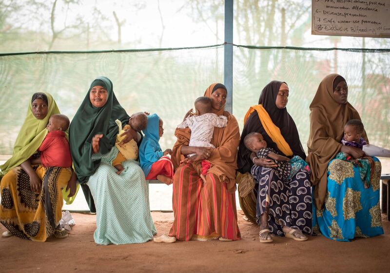 Mothers wait at an MSF health post in Dagahaley to get a nutrition check-up for their children.