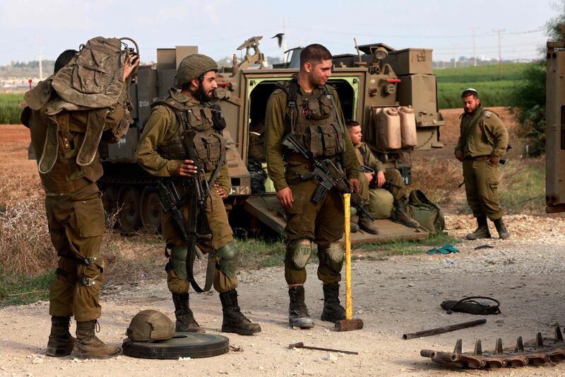 Israeli troops gather at an undisclosed location on the border with the Gaza Strip. AFP