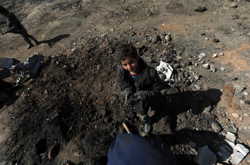 A boy is pictured at a makeshift oil refinery near Tarhin, in Aleppo, Syria. AFP