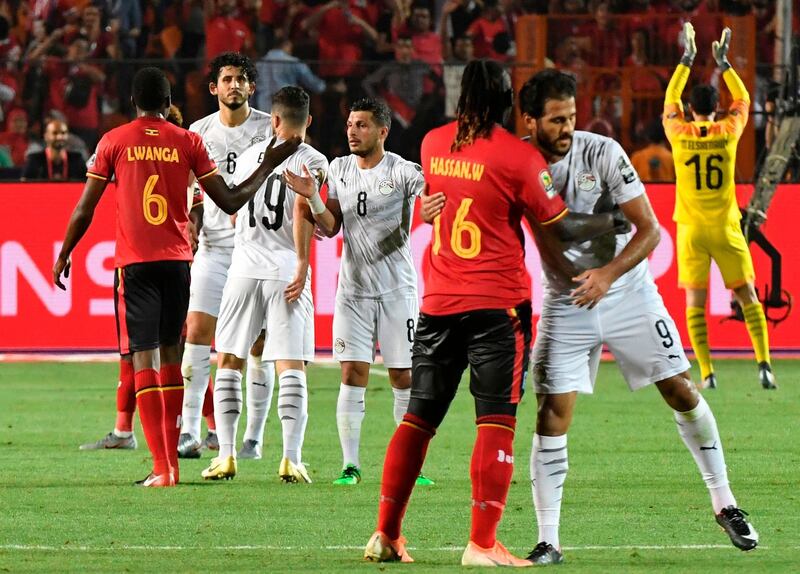 Players greet each other after the 2019 Africa Cup of Nations Group A match between Uganda and Egypt at the Cairo International Stadium. Egypt won the match 2-0 but both teams advanced to the last 16. AFP