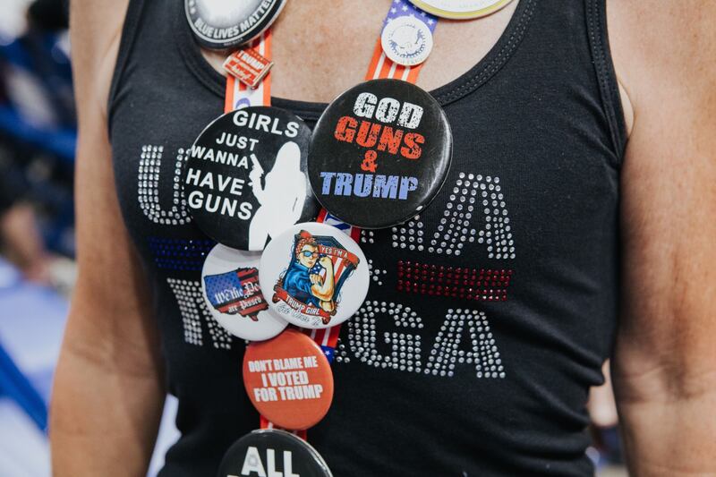 An attendee of the rally shows badges displaying 'Maga' messaging. President Joe Biden claimed adherents of Mr Trump's 'Make America Great Again' doctrine are undermining US democracy. Bloomberg