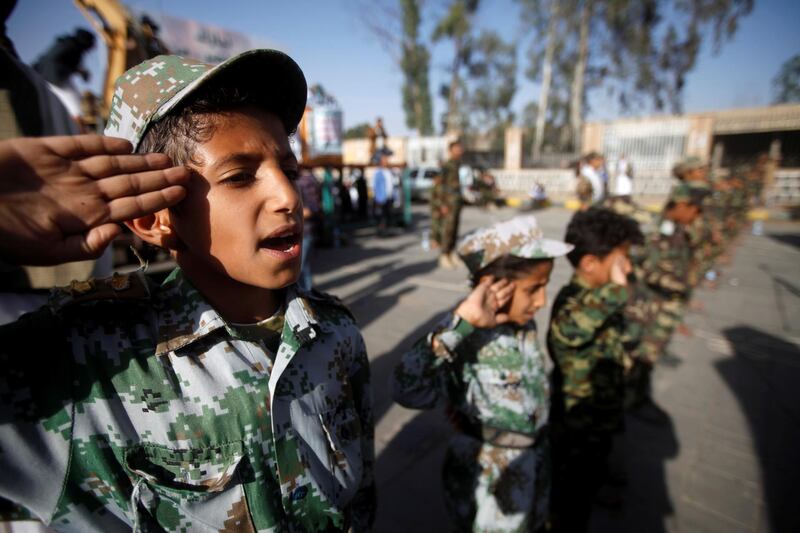 A boy salutes the flag as he and supporters of the Houthi movement attend a rally to celebrate following claims of military advances by the group near the borders with Saudi Arabia, in Sanaa, Yemen October 4, 2019. REUTERS/Mohamed al-Sayaghi