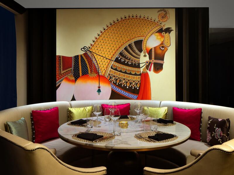 Colourful artworks and a cosy booth at Taj Dubai's Bombay Brasserie. Courtesy Taj Dubai