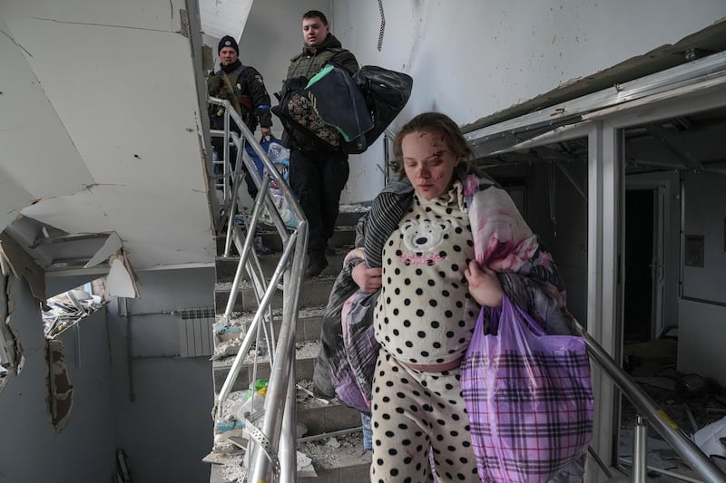 Mariana Vishegirskaya walks down stairs in a maternity hospital damaged by shelling in Mariupol. AP Photo