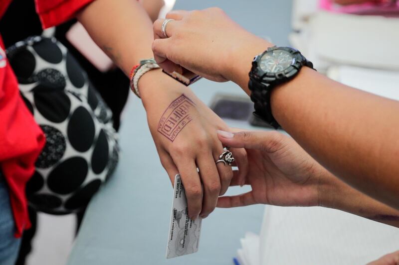 A tourist gets stamped on entry to Boracay.