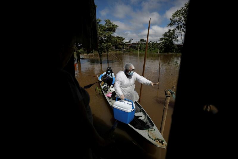 A health worker arrives by canoe to administer Covid-19 vaccines to residents in Anama, Amazonas state, Brazil. Reuters