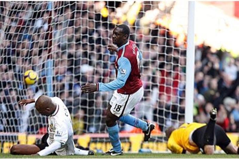 Aston Villa's Emile Heskey, centre, spins away to celebrate after making it 4-1 yesterday.