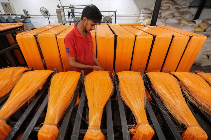A labourer sorts plastic yarn made from recycled plastic bottles at Whiteline Industries in Colombo, Sri Lanka. EPA