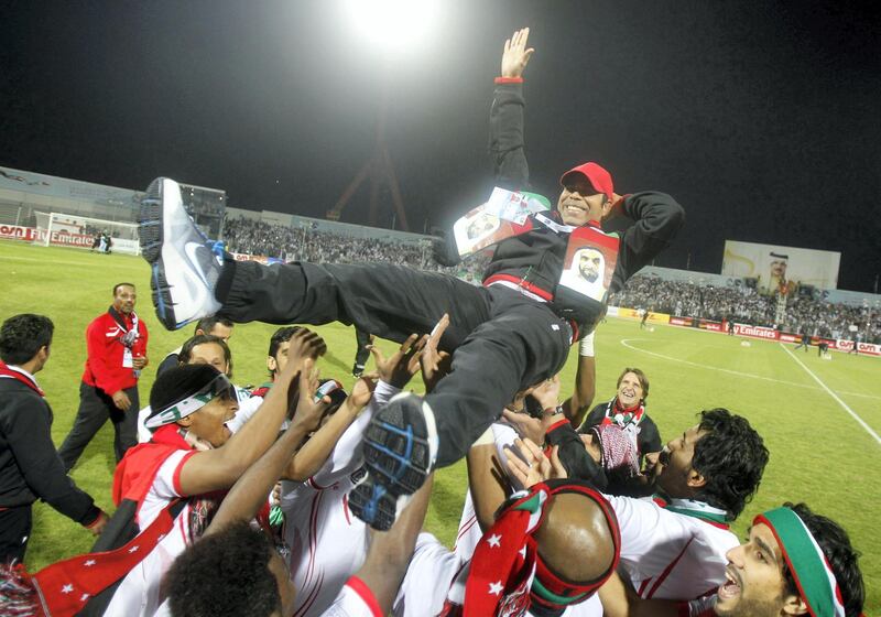UAE's coach Mahdi Ali Hasan (C) celebrates with his team after winning their final game against Iraq at the Gulf Cup Tournament in Isa Town, January 18, 2013. REUTERS/Mohammed Dabbous (BAHRAIN - Tags: SPORT SOCCER) *** Local Caption ***  BAH12D_SOCCER-_0118_11.JPG