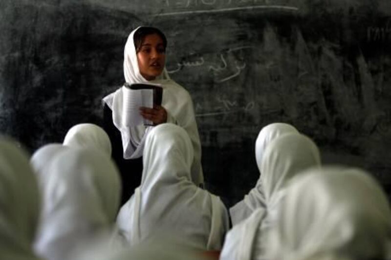 An Afghan pupil reads a poem to her classmates at a girls school in Kabul on September 20, 2010. The Taliban banned female education and work during their brutal 1996-2001 rule. Since their overthrow in a US-led invasion, millions of girls have returned to the classroom and many women now work outside the home. AFP PHOTO/PATRICK BAZ