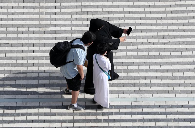 Visitors taking selfies to record their presence on the final day of Expo 2020 Dubai. Pawan Singh / The National