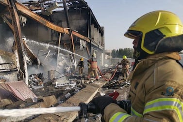 Dubai Civil Defence teams extinguish a fire at Dubai Investment Park on Tuesday. One firefighter died while tackling the blaze. Courtesy: Dubai Civil Defence  