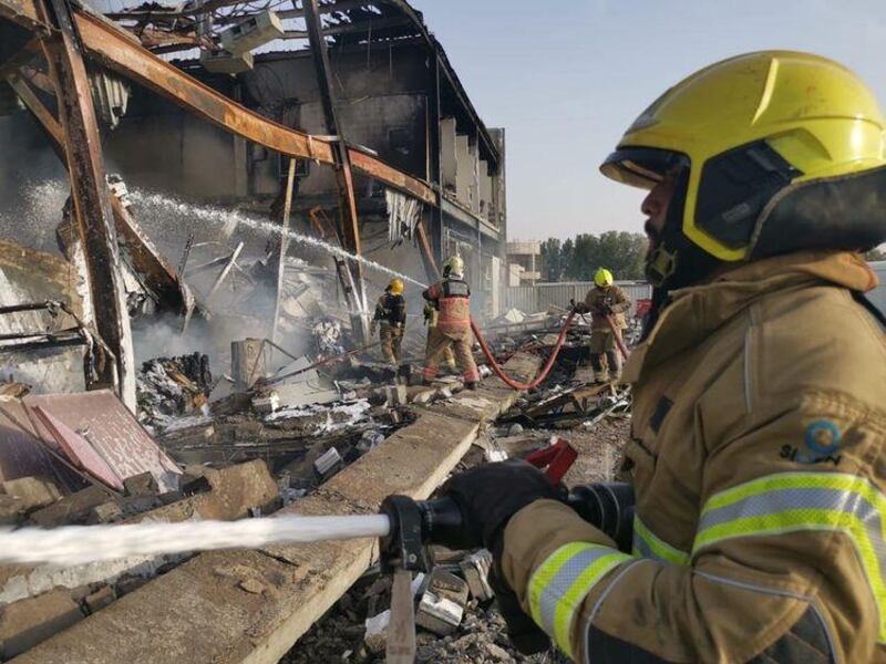 Dubai Civil Defence teams extinguish a fire at Dubai Investment Park on Tuesday. One firefighter died while tackling the blaze. Courtesy: Dubai Civil Defence  