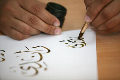 DUBAI, UNITED ARAB EMIRATES - April 8: Khaled Al-Saai’i, Arabic calligrapher and painter, giving a calligraphy demonstration in the Calligraphers' Studio at the Sharjah Museum for the Art of Arabic Calligraphy, in Sharjah on April 8, 2008. (Randi Sokoloff / The National) *** Local Caption *** RS020-Calligraphy.jpg