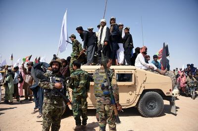 (FILES) In this file photo taken on June 17, 2018, Afghan Taliban militants and residents stand on a armoured Humvee vehicle of the Afghan National Army (ANA) as they celebrate a ceasefire on the third day of Eid in Maiwand district of Kandahar province. The Taliban have offered a brief ceasefire to their US counterparts in Doha, two insurgent sources said on January 16, a move which could allow the resumption of talks seeking a deal for Washington to withdraw troops from Afghanistan. - 
 / AFP / JAVED TANVEER
