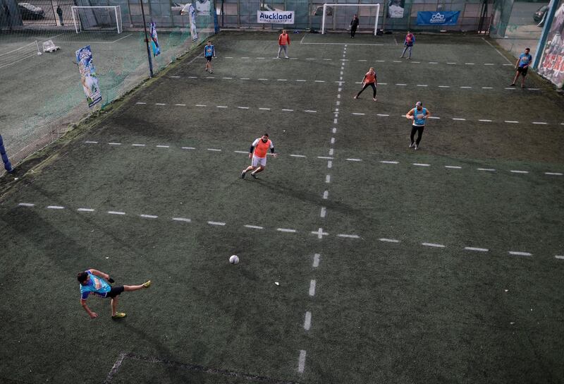 Men play football at a local club in Pergamino, Argentina where soccer field has been divided into 12 rectangles to keep players from making physical contact. AP Photo