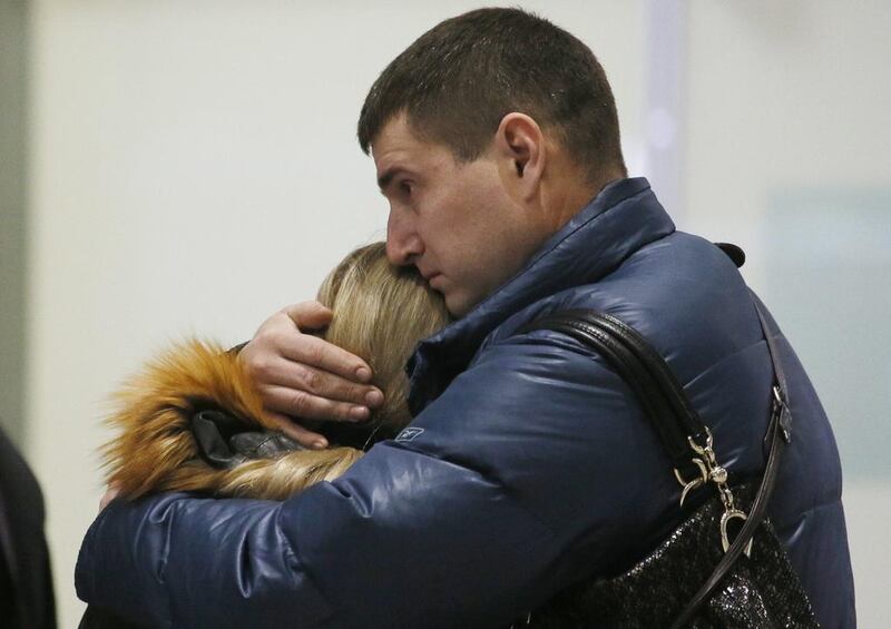 Relatives react after a Russian airliner with 217 passengers and seven crew aboard crashed, as people gather at Russian airline Kogalymavia’s information desk at Pulkovo airport in St.Petersburg on October 31. Dmitry Lovetsky/AP 