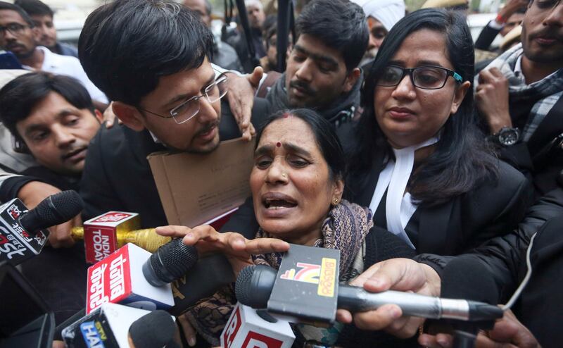 Asha Devi, mother of the victim of the fatal 2012 gang rape on a moving bus, speaks to the media as she leaves a court in New Delhi, India, Tuesday, Jan. 7, 2020. A death warrant was issued Tuesday for the four men convicted in the 2012 gang rape and murder of a young woman on a New Delhi bus that galvanized protests across India and brought global attention to the country's sexual violence epidemic. A New Delhi court scheduled the hangings for Jan. 22, the Press Trust of India news agency reported. (AP Photo)