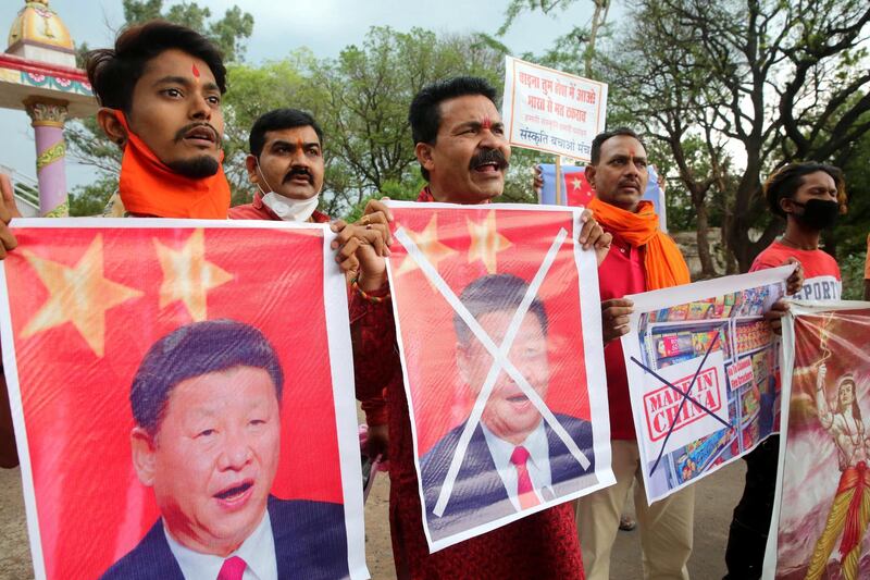 epa08488454 Activists of Sanskriti Bhchan Manch shout slogans as they stage a protest against China, holding posters of Chinese President Xi Jinping, in Bhopal, India, 16 June 2020. According to media reports, one officer of the Indian Army and two soldiers were killed in a fatal faceoff with Chinese soldiers in Galwan Valley region of the eastern Ladakh.  EPA/SANJEEV GUPTA