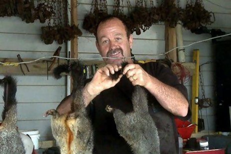 Trapper Stu Flett hangs out possum carcasses to dry in his garage at his home in Matapouri, on New Zealand's North Island. Erica Berenstein / AFP