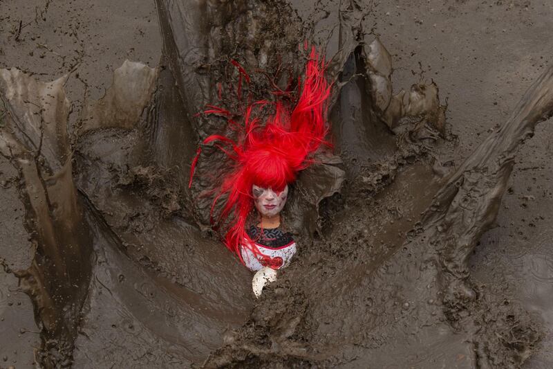 A competitor falls in a muddy pool as they take part in the Tough Guy endurance event near Wolverhampton, central England. AFP