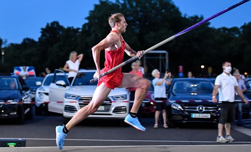 Pole vaulter Karsten Dilla of Germany competes during a "Flight Night" event at a drive-in cinema due to the coronavirus pandemic orders in Duesseldorf, Germany. AP Photo