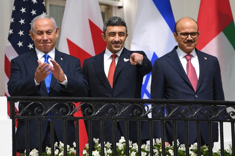 Sheikh Abdullah, with Mr Netanyahu, left, and Mr Al Zayani at the signing of the Abraham Accord on the South Lawn of the White House. AFP