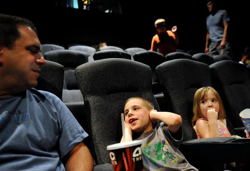 David Bukovinsky and his children, Connor, 6, and Megan, 4, enjoy a Sensory Friendly Film screening of "Despicable Me," at AMC Westminster Promenade 24, in Westminster, CO, , on July 17, 2010. Once a month AMC and the Autism Society of Colorado host a screening of a first-run film for children with autism and other special needs. Connor has autism. The showing gives families an opportunity to go to the theatre without concern of behavior issues that might keep them away otherwise. (Craig F. Walker / The Denver Post)  (Photo By Craig F. Walker/The Denver Post via Getty Images)