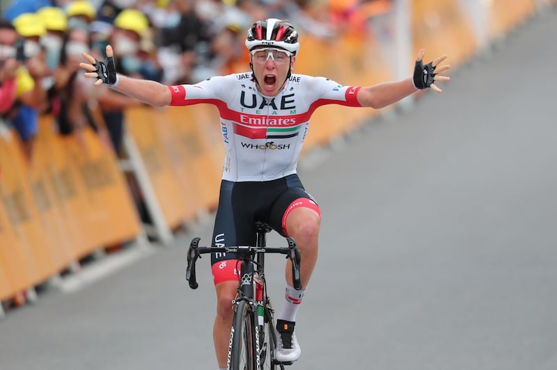 Stage winner UAE Team Emirates rider Slovenia's Tadej Pogacar celebrates as he crosses the finish line at the end of the 9th stage of the Tour de France. AFP