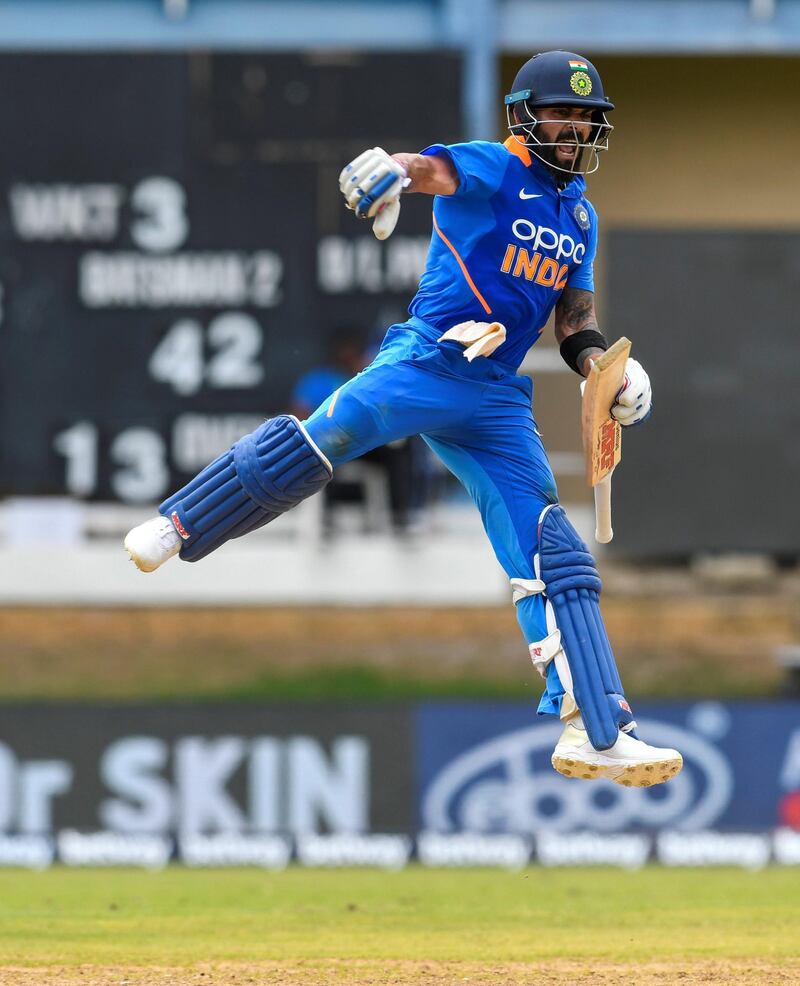 Virat Kohli of India celebrates his century (100 runs) during the 2nd ODI match between West Indies and India at Queens Park Oval in Port of Spain, Trinidad and Tobago, on August 11, 2019. (Photo by Randy Brooks / AFP)