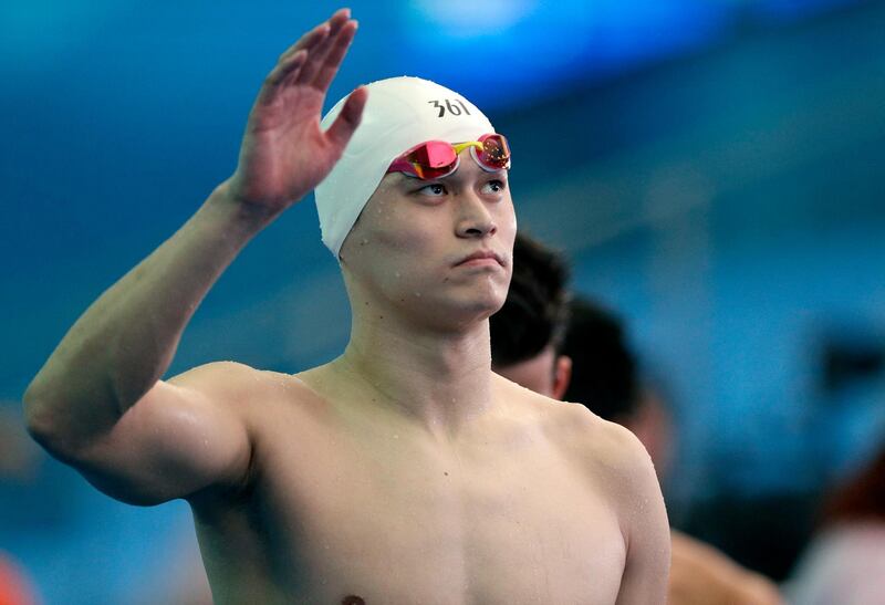 FILE - In this Friday, July 26, 2019 file photo, China's Sun Yang waves following the men's 4x200m freestyle relay heats at the World Swimming Championships in Gwangju, South Korea. Ahead of a verdict pending within days in the doping case of three-time Olympic champion Sun Yang, a Swiss supreme court document on Tuesday, Feb. 25, 2020 shows swimmingâ€™s governing body wanted to stop the World Anti-Doping Agencyâ€™s appeal. World swim body FINA supported arguments by Sunâ€™s lawyers who asked the Court of Arbitration for Sport to throw out WADAâ€™s case early last year in a pre-trial dispute over an alleged conflict of interest for the agencyâ€™s American lead prosecutor, Richard Young. (AP Photo/Mark Schiefelbein, file)