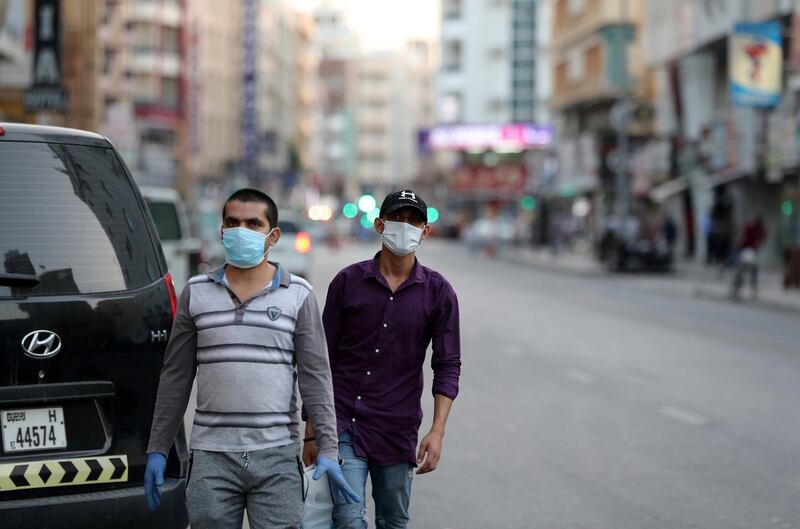 DUBAI, UNITED ARAB EMIRATES , April 27 – 2020 :- People walking on the streets in Al Ras area in Deira Dubai. Authorities ease the restriction for the residents after almost a month long locked down of Al Ras district. (Pawan Singh / The National) For News/Standalone/Online/Instagram