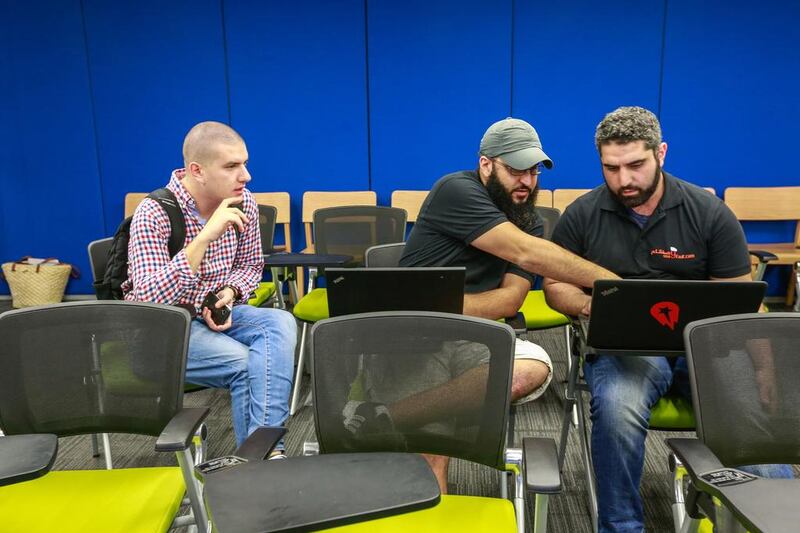 From left: Event mentor Mohamed Mehanna, Ahmed AbuSaad and Abdulhadi Hafez at the Dubai Startup Weekend at Astrolabs Dubai. Victor Besa for The National
