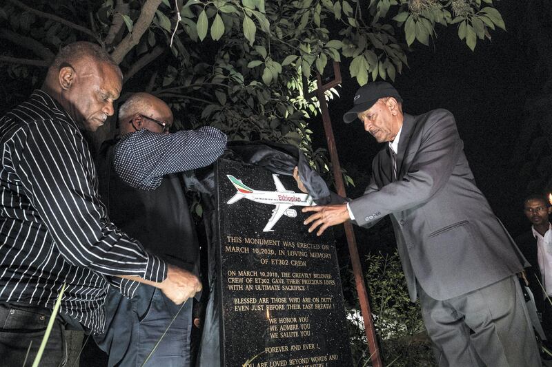 Getachew Tessema (R), father of Ethiopian Airlines flight 302 captain Yared Getachew, unveils a plaque during a commemoration  ceremony held by the Airline Pilots' Association of Ethiopia on the first anniversary of the Ethiopian Airlines Flight 302 crash in Addis Ababa, Ethiopia, on March 10, 2020. - Ethiopian Airlines on March 10, 2020, marked the one-year anniversary of the crash of Flight 302 by bringing relatives of the dead together for a ceremony at the crash site southeast of the capital, Addis Ababa. The crash of the Nairobi-bound Boeing 737 MAX six minutes after takeoff on March 10, 2019, killed all 157 people on board, triggering the global grounding of the MAX and the worst crisis in Boeing's history. (Photo by EDUARDO SOTERAS / AFP)