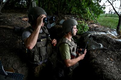 Ukrainian soldiers keep watch at a position near a front line, in the Zaporizhzhia region. Reuters