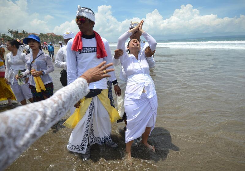 A Balinese woman in a trance gestures during a Melasti ceremony at Petitenget beach near Denpasar, Bali. AFP