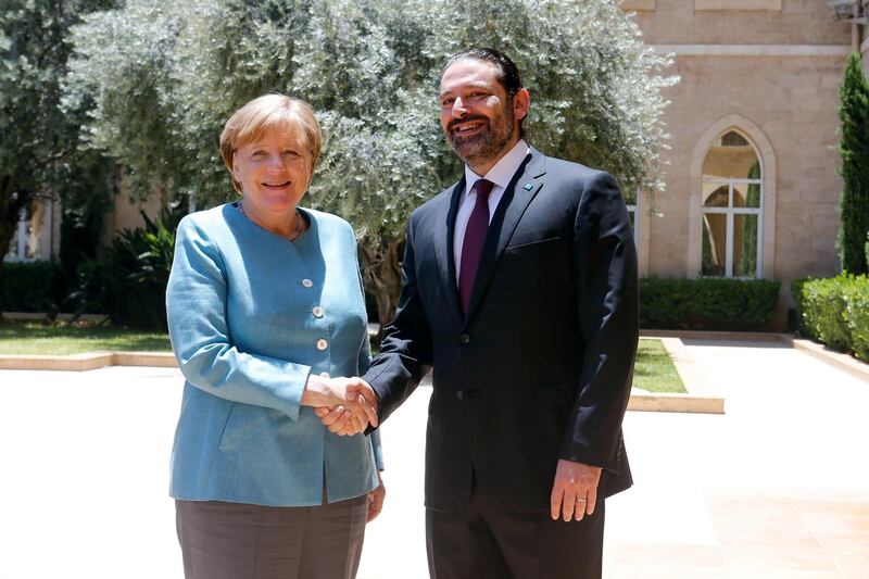 Lebanese Prime Minister-designate Saad al-Hariri shakes hands with German Chancellor Angela Merkel at the government palace in Beirut, Lebanon June 22, 2018. REUTERS/Mohamed Azakir