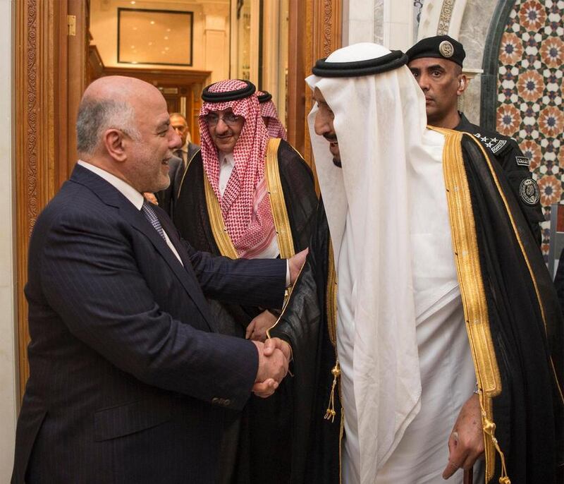 King Salman bin Abdulaziz Al Saud, right, and Iraq's prime minister Haider Al Abbadi, greet each other in Riyadh on the first stop of Mr Abadi's three-day tour of the Arabian Gulf. Saudi Press Agency / EPA