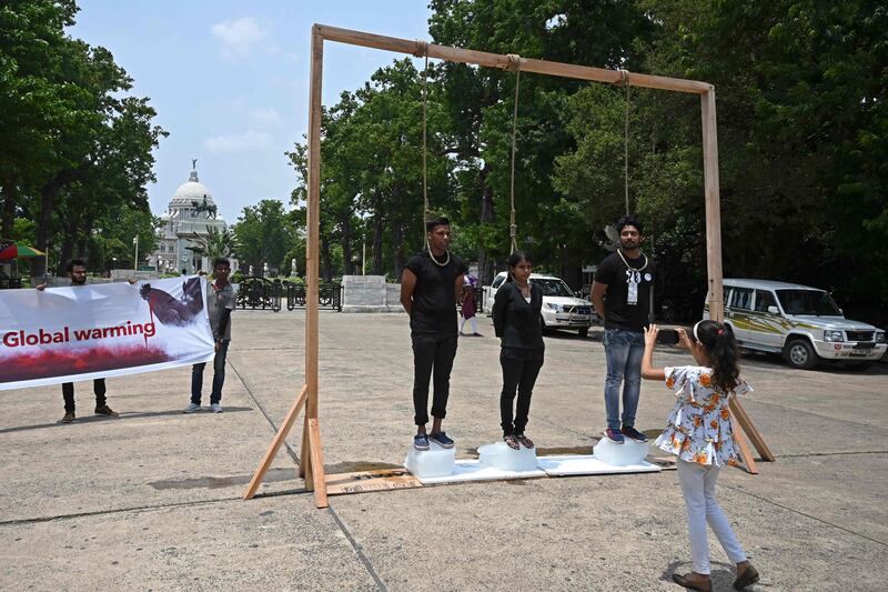 Activists take part in a demonstration to raise awareness of global warming, during an event to mark World Environment Day in Kolkata. AFP