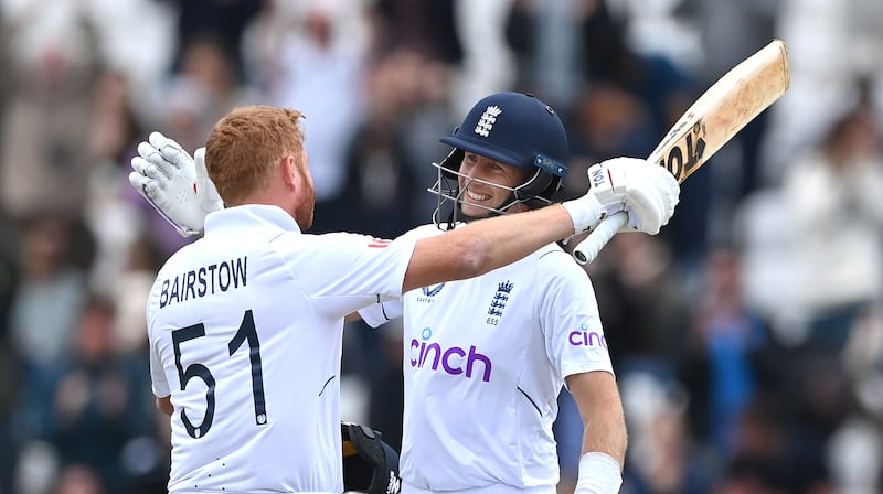 England batsmen Jonny Bairstow and Joe Root celebrate. Getty 