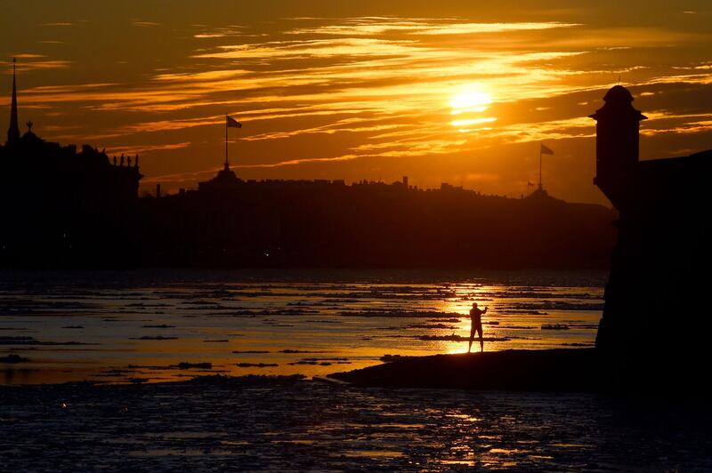 A winter swimming enthusiast is seen after taking a swim in the partially frozen Neva river at sunset in central Saint Petersburg. AFP